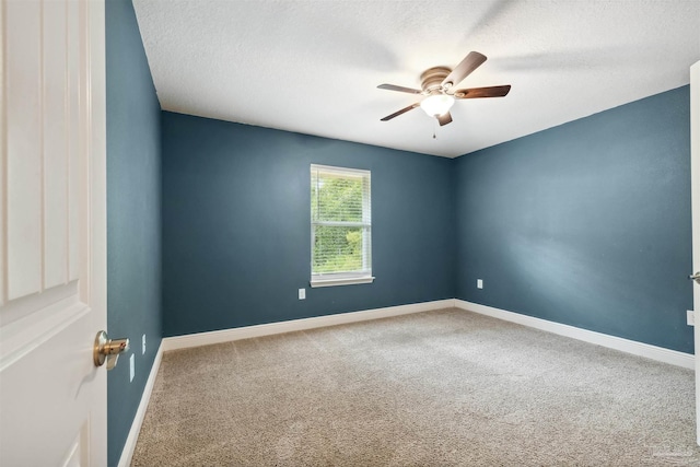 carpeted empty room featuring ceiling fan and a textured ceiling