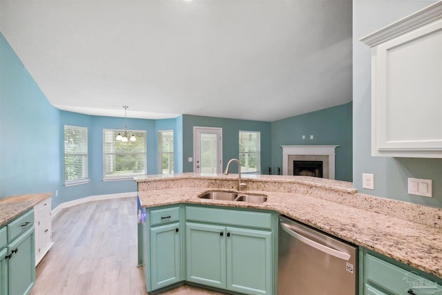 kitchen with sink, light hardwood / wood-style flooring, light stone counters, stainless steel dishwasher, and white cabinets