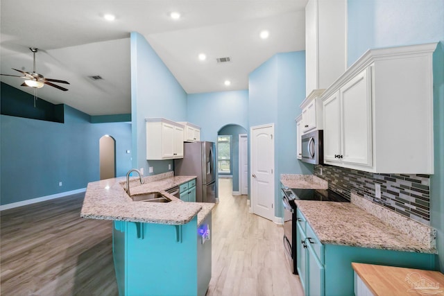 kitchen featuring sink, white cabinets, light hardwood / wood-style flooring, and stainless steel appliances