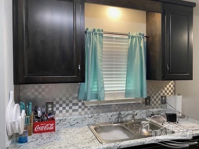 kitchen featuring decorative backsplash and sink