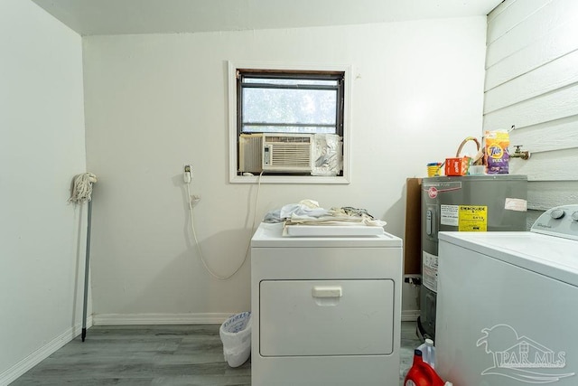 laundry room with washer and clothes dryer, cooling unit, wood-type flooring, and electric water heater