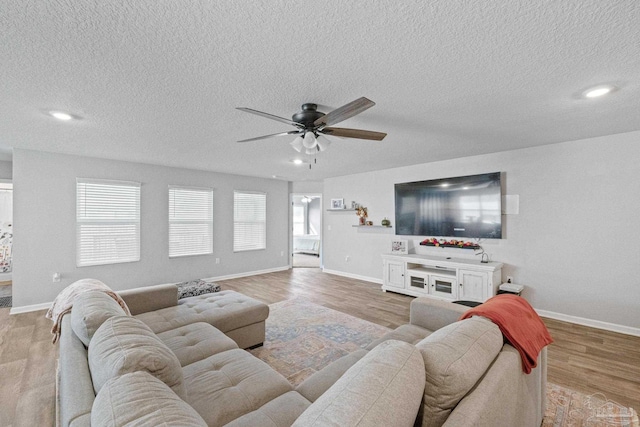 3897 James Stovall St, Pensacola, FL 32526 - living room featuring a ceiling fan, a textured ceiling, baseboards, wood finished floors, and recessed lighting