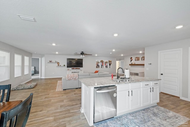 kitchen featuring a center island with sink, white cabinetry, light wood-type flooring, sink, and stainless steel dishwasher