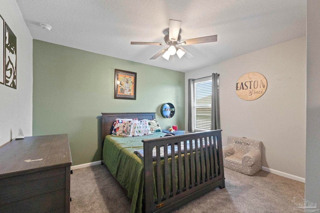 bedroom featuring ceiling fan, a textured ceiling, and carpet