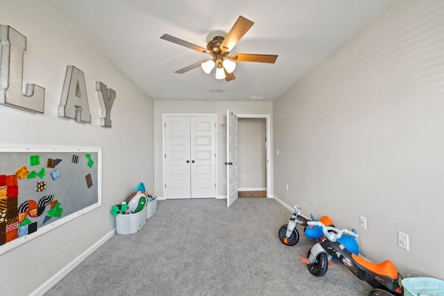 recreation room featuring ceiling fan and carpet