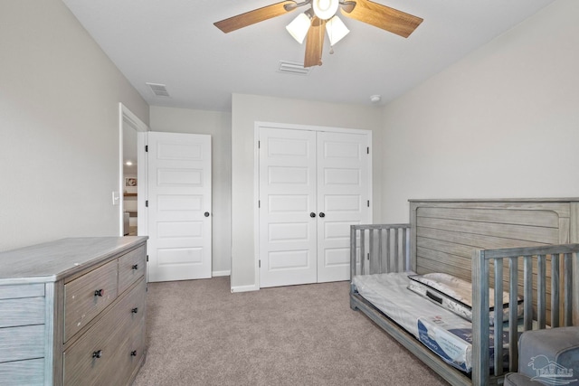 carpeted bedroom featuring a closet and ceiling fan