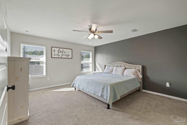 3897 James Stovall St, Pensacola, FL 32526 - carpeted bedroom featuring baseboards, a textured ceiling, and ceiling fan