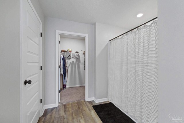 3897 James Stovall St, Pensacola, FL 32526 - bathroom featuring wood finished floors, baseboards, curtained shower, a spacious closet, and recessed lighting