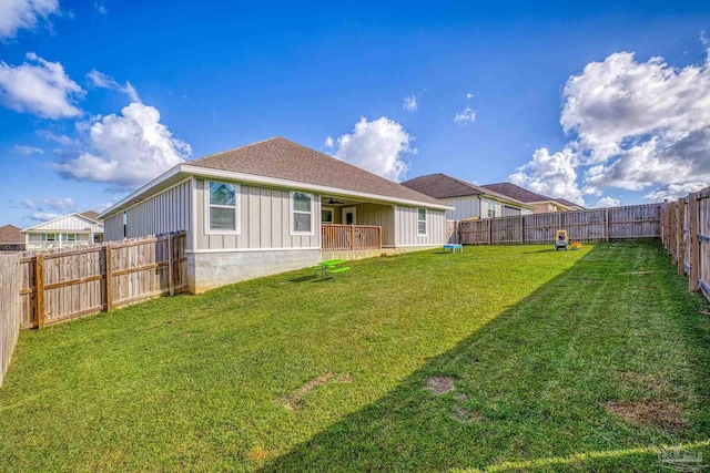 rear view of house with a yard