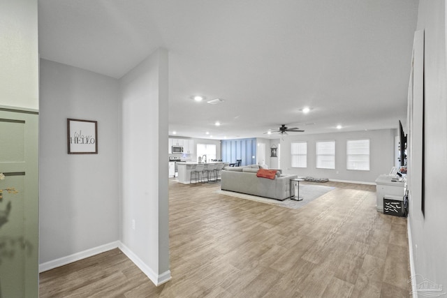 3897 James Stovall St, Pensacola, FL 32526 - living area featuring recessed lighting, a ceiling fan, light wood-type flooring, and baseboards