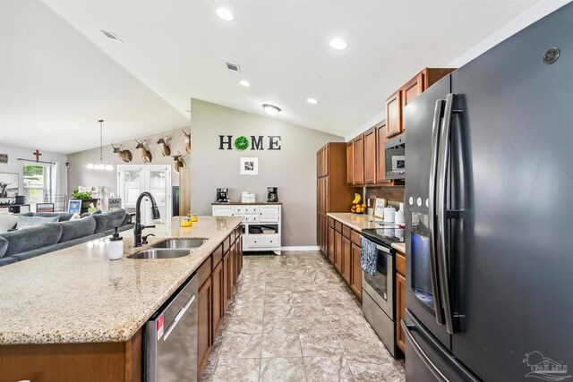 kitchen featuring stainless steel appliances, sink, light stone counters, light tile patterned floors, and lofted ceiling