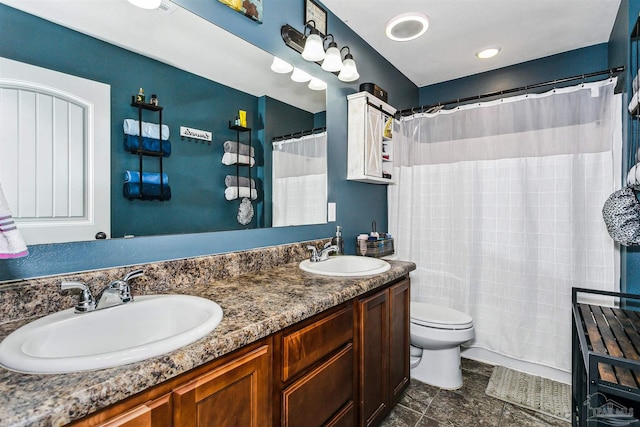 bathroom featuring toilet, tile patterned floors, and double vanity