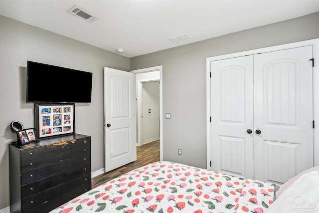 bedroom featuring dark hardwood / wood-style flooring and a closet