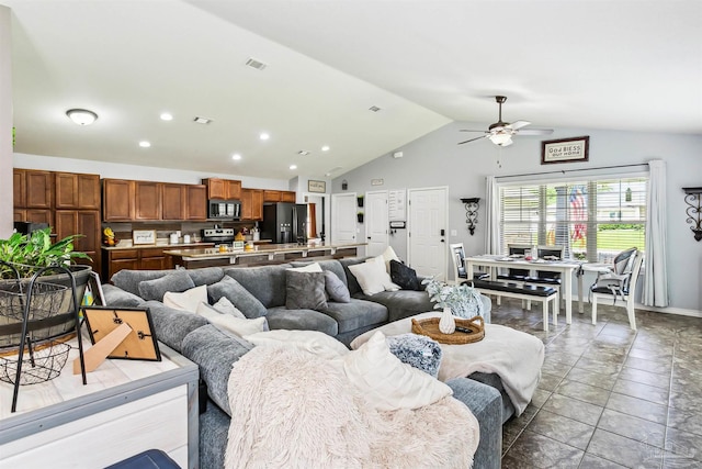 living room with light tile patterned flooring, ceiling fan, and high vaulted ceiling