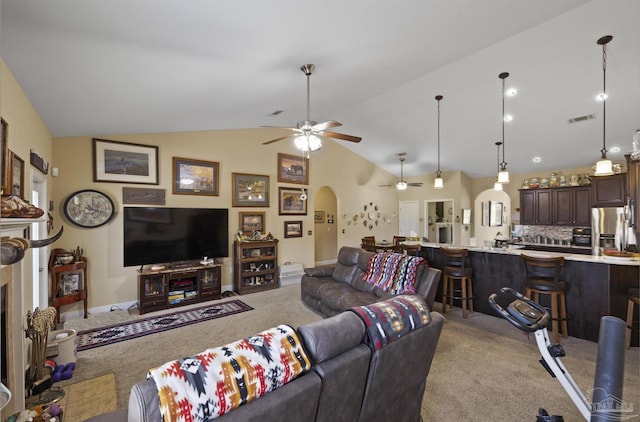 carpeted living room featuring vaulted ceiling and ceiling fan