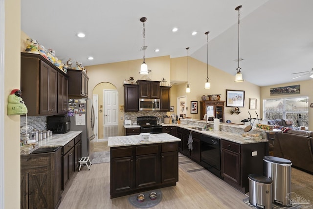 kitchen featuring decorative light fixtures, sink, dark brown cabinets, and black appliances