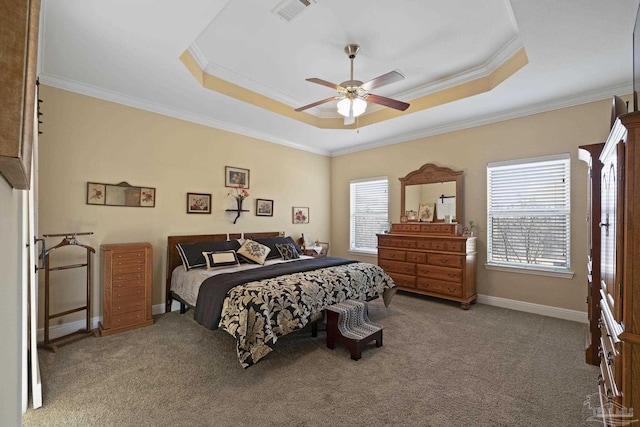 carpeted bedroom featuring a raised ceiling, ornamental molding, and ceiling fan