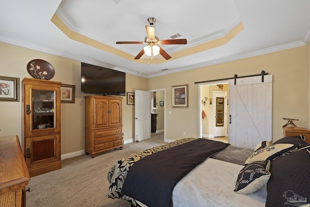 carpeted bedroom featuring ornamental molding, a raised ceiling, ceiling fan, and a barn door