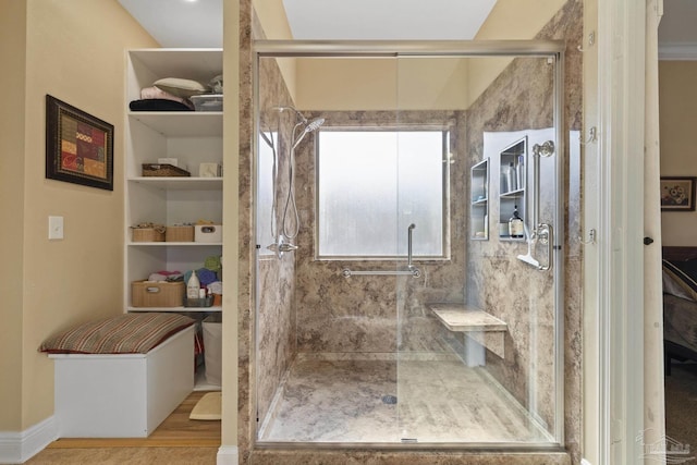 bathroom featuring hardwood / wood-style floors and a shower with shower door