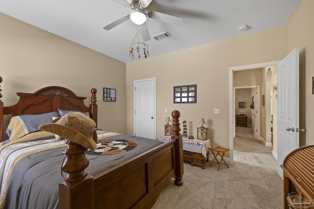 bedroom with vaulted ceiling, light colored carpet, and ceiling fan