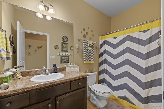 bathroom with vanity, tile patterned floors, toilet, and walk in shower