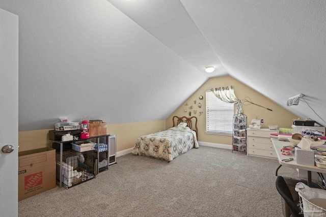 carpeted bedroom with vaulted ceiling and a textured ceiling