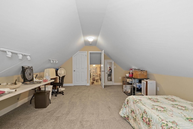 bedroom with light colored carpet and vaulted ceiling