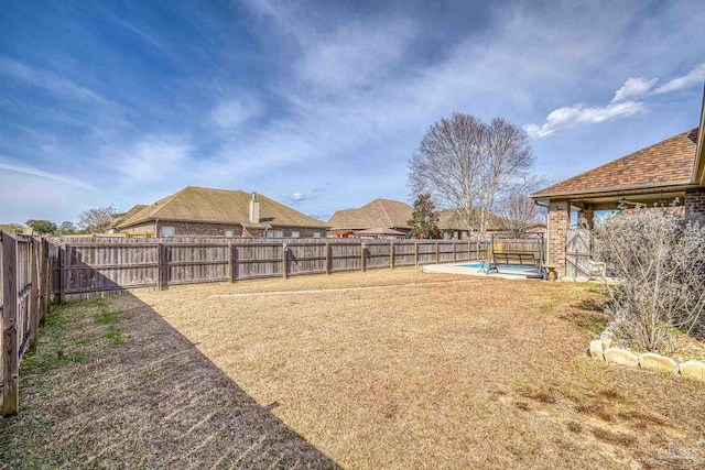 view of yard with a fenced in pool