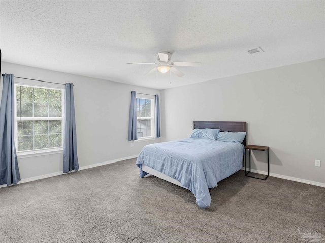 bedroom featuring carpet flooring, a ceiling fan, baseboards, and a textured ceiling