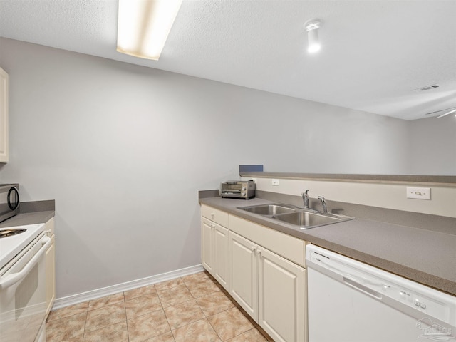 kitchen featuring white appliances, light tile patterned floors, visible vents, baseboards, and a sink