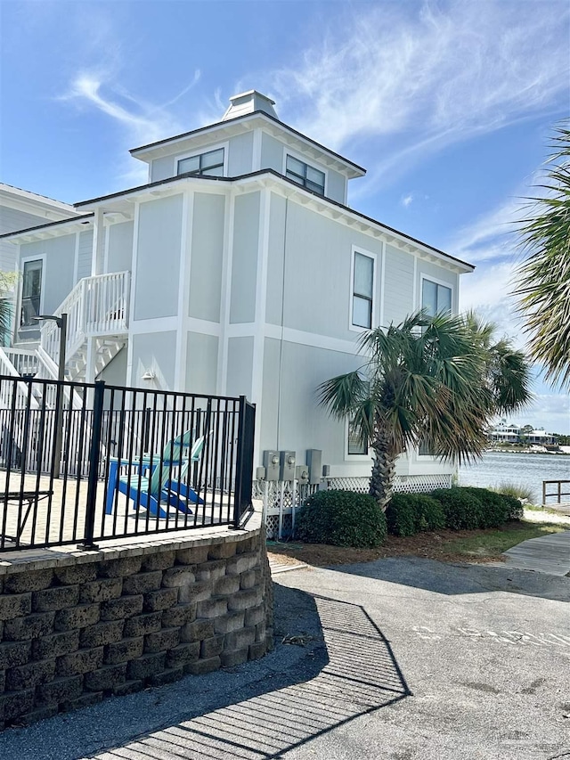 view of property exterior featuring a water view