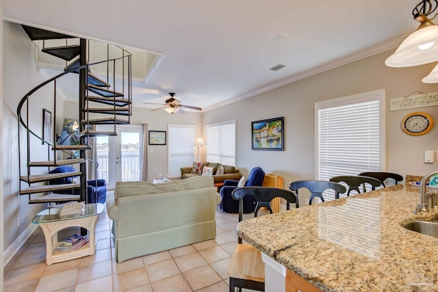 tiled living room featuring ornamental molding, sink, and ceiling fan