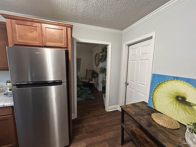 kitchen featuring ornamental molding, a textured ceiling, stainless steel fridge, and dark hardwood / wood-style flooring