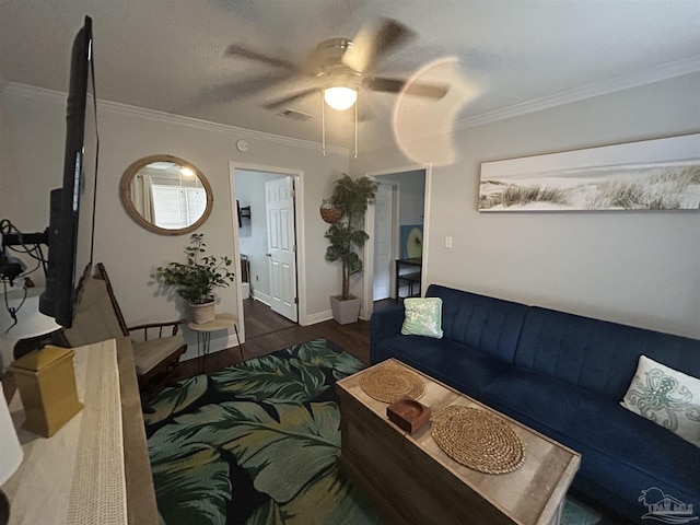 living room featuring ornamental molding, ceiling fan, and dark hardwood / wood-style flooring