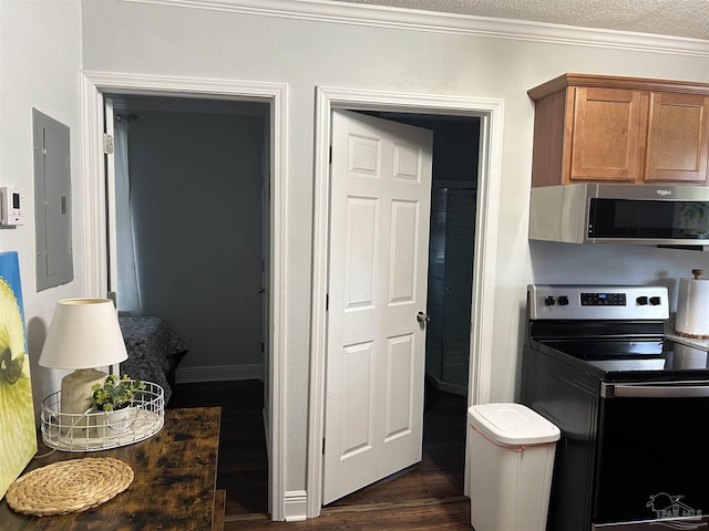 kitchen featuring appliances with stainless steel finishes, dark hardwood / wood-style floors, electric panel, crown molding, and a textured ceiling