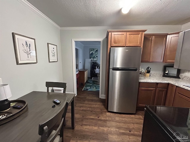 kitchen with stainless steel fridge, electric range, dark hardwood / wood-style floors, ornamental molding, and a textured ceiling