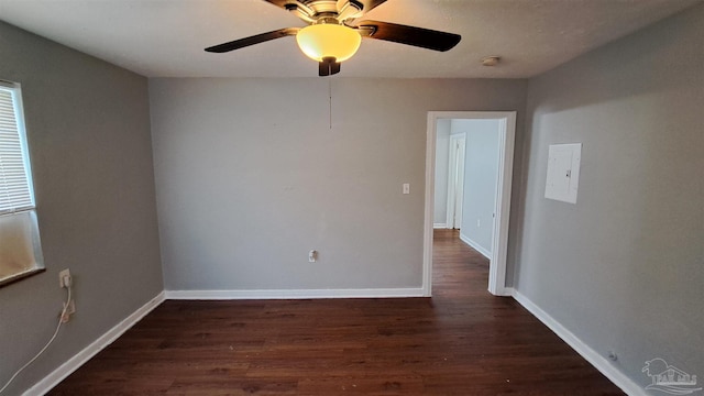 empty room featuring ceiling fan and dark wood-type flooring