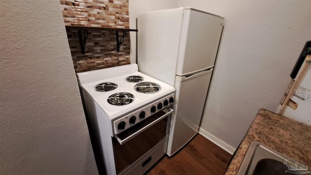 kitchen with dark hardwood / wood-style floors, white appliances, and water heater