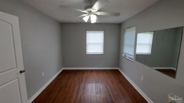 unfurnished room featuring ceiling fan and dark wood-type flooring