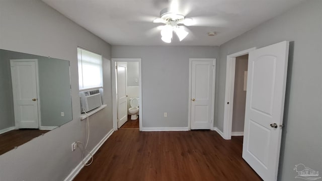 unfurnished bedroom featuring connected bathroom, ceiling fan, dark hardwood / wood-style flooring, and cooling unit