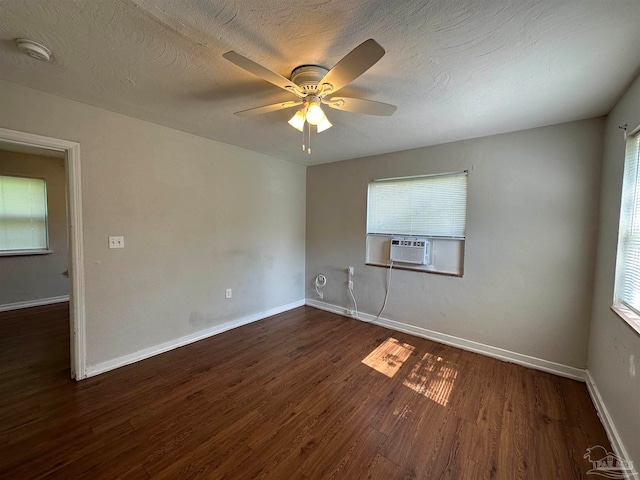 unfurnished room with dark hardwood / wood-style floors, ceiling fan, a textured ceiling, and a wealth of natural light