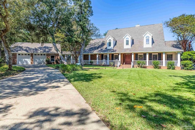 cape cod house featuring a porch, a front yard, and a garage