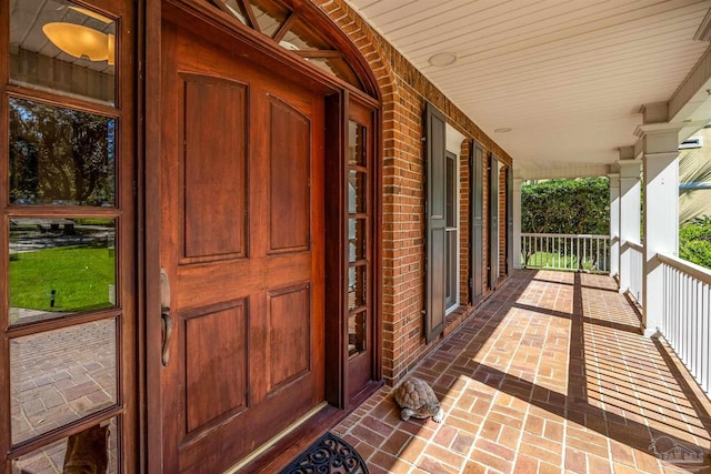 doorway to property featuring covered porch