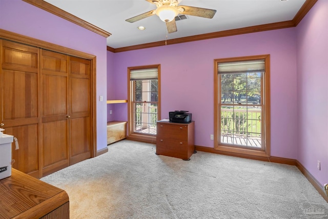 office with crown molding, light carpet, and ceiling fan