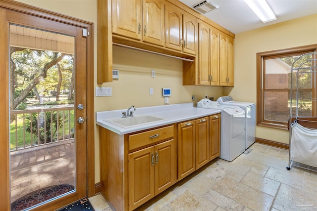 washroom featuring cabinets, independent washer and dryer, sink, and plenty of natural light