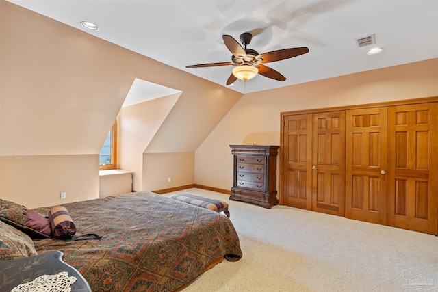 bedroom featuring a closet, ceiling fan, vaulted ceiling, and carpet floors