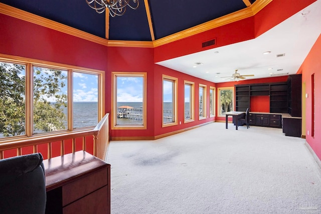 sunroom with a wealth of natural light, a water view, and ceiling fan