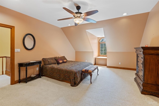 bedroom featuring vaulted ceiling, light colored carpet, and ceiling fan