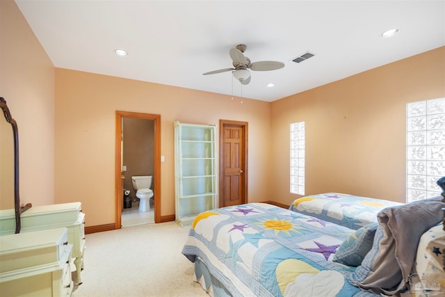 carpeted bedroom featuring ceiling fan and ensuite bath