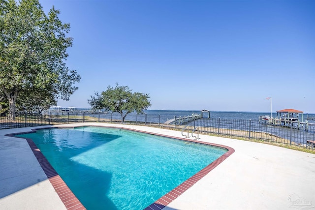 view of pool with a patio area and a water view